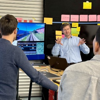 Traila engineers reviewing a rail-vehicle simulation in the office.