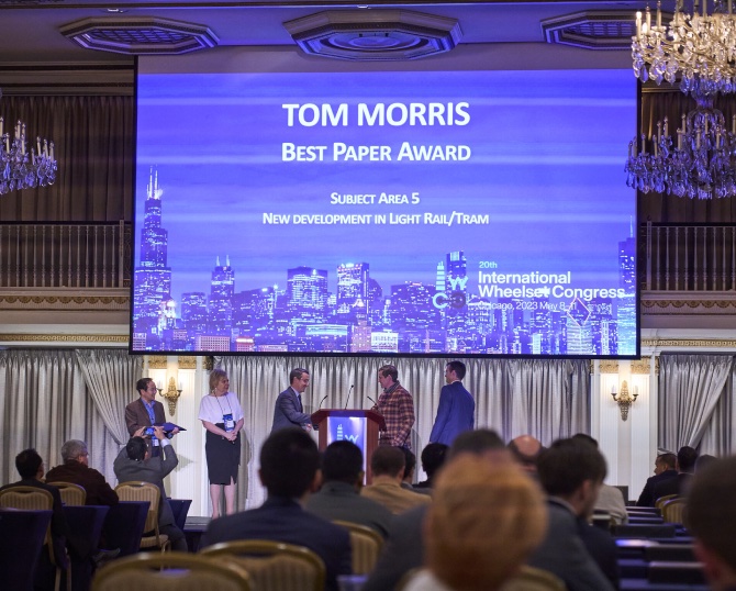 Photograph of an award-ceremony stage at an international rail-industry engineering conference.