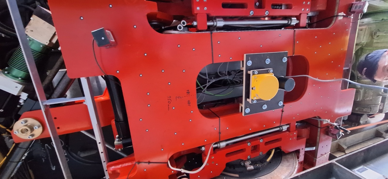 The active-steering bogie and wheel mounted beneath the TX4 test vehicle, Traila red bodywork visible above.